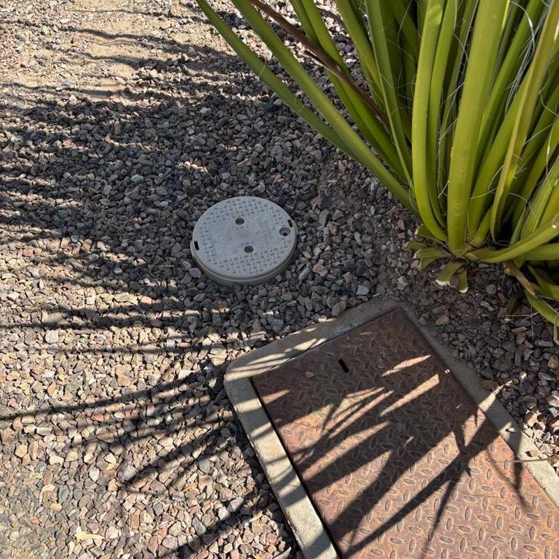 Pressure relief valve and water curb stop box access in gravel