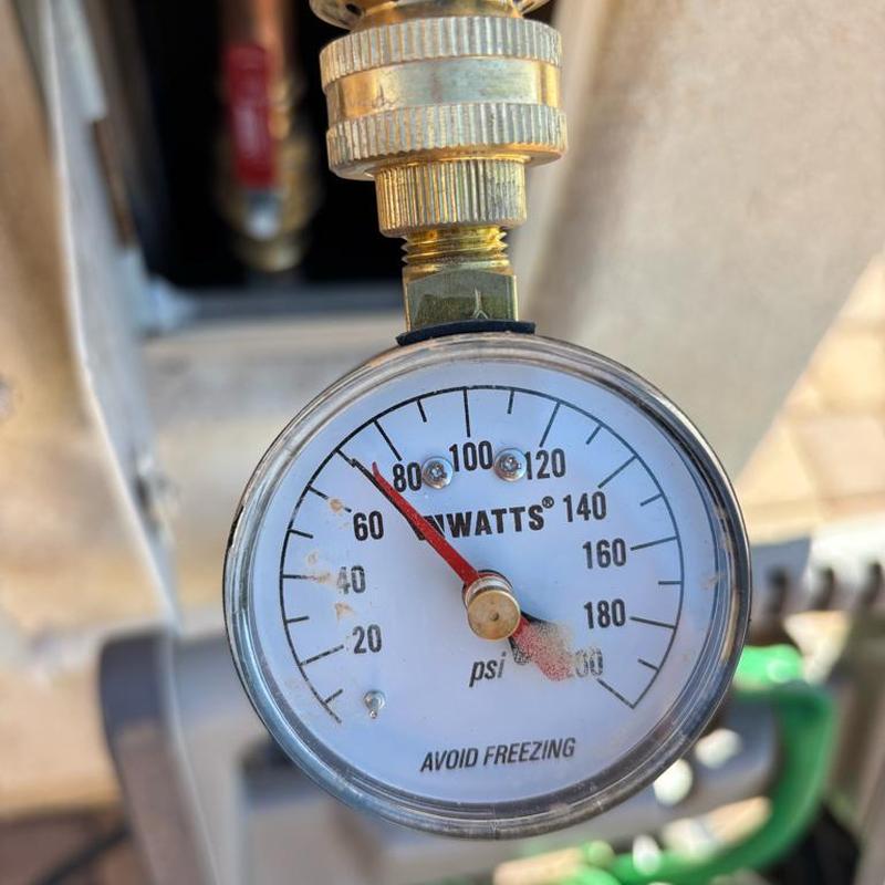Pressure relief valve gauge reading at 70 psi in ground box