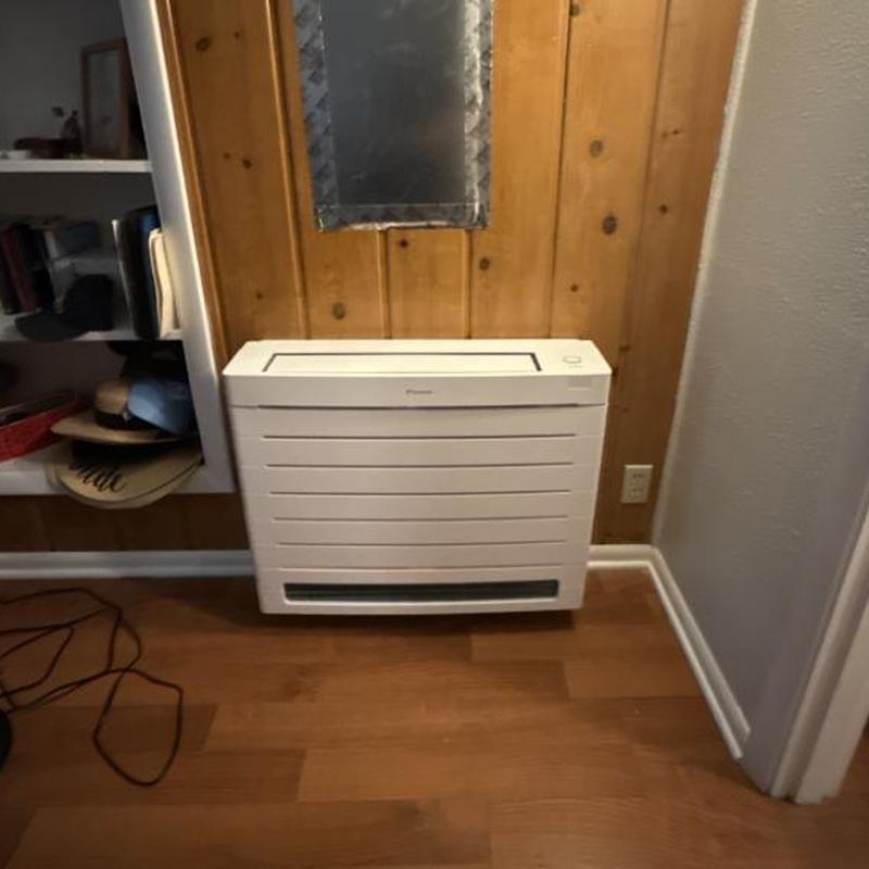 Heat pump indoor unit installed on wood panel wall Heat pump indoor unit installed on wood panel wall