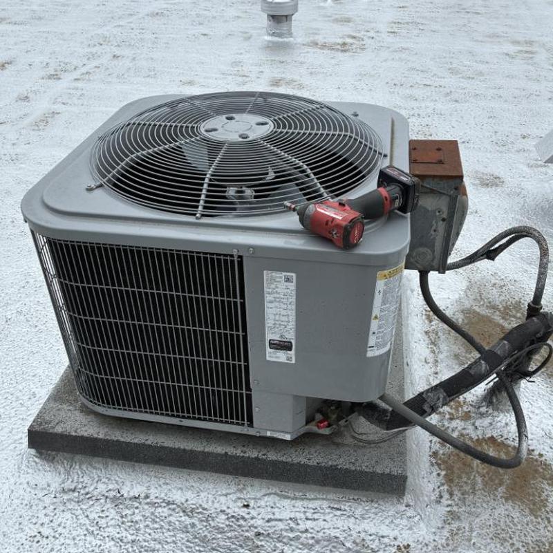Rooftop air conditioning unit with cordless drill atop Rooftop air conditioning unit with cordless drill atop
