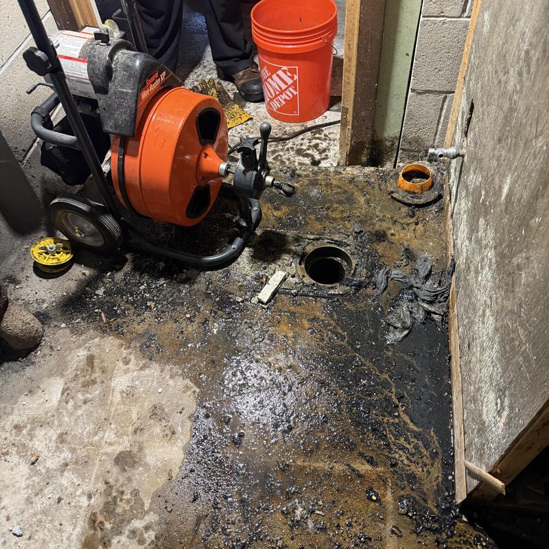 Main sewer line with drain auger and clogged debris