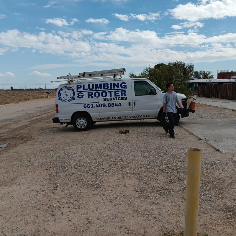 Copper water service installation truck and worker outdoors Copper water service installation truck and worker outdoors