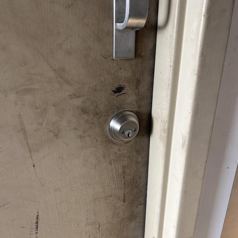 Double deadbolt lock on worn wood door in frame Double deadbolt lock on worn wood door in frame