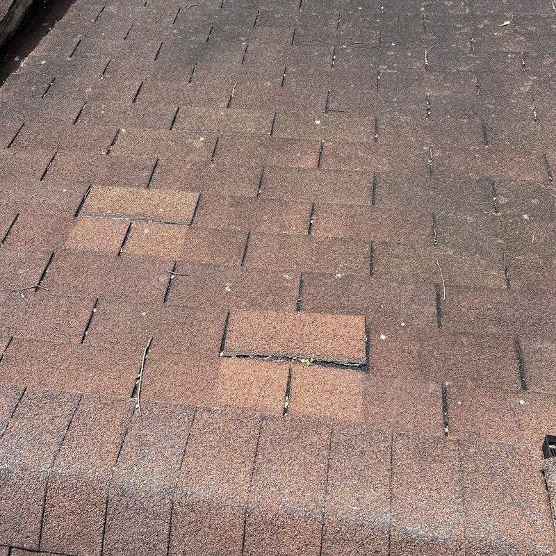 Asphalt shingles with hail damage on residential roof