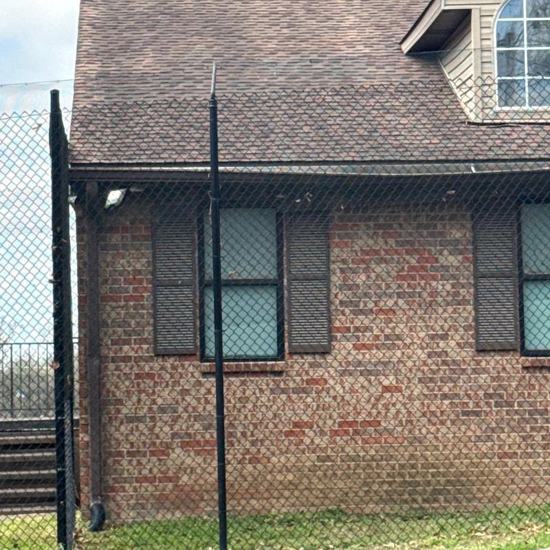 Asphalt shingle roof with hail damage on commercial building