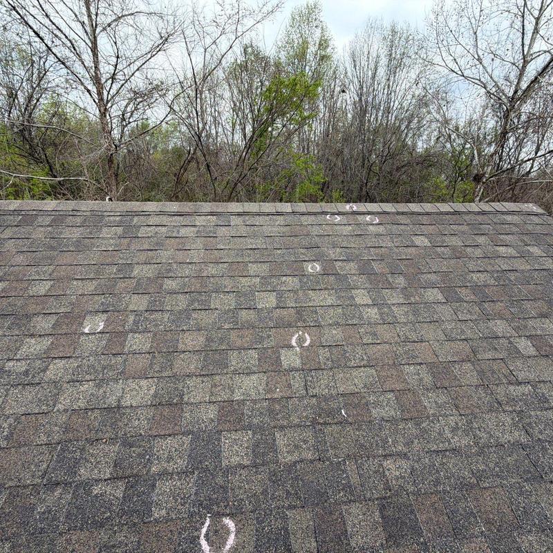Asphalt shingle roofing with chalk-marked hail damage