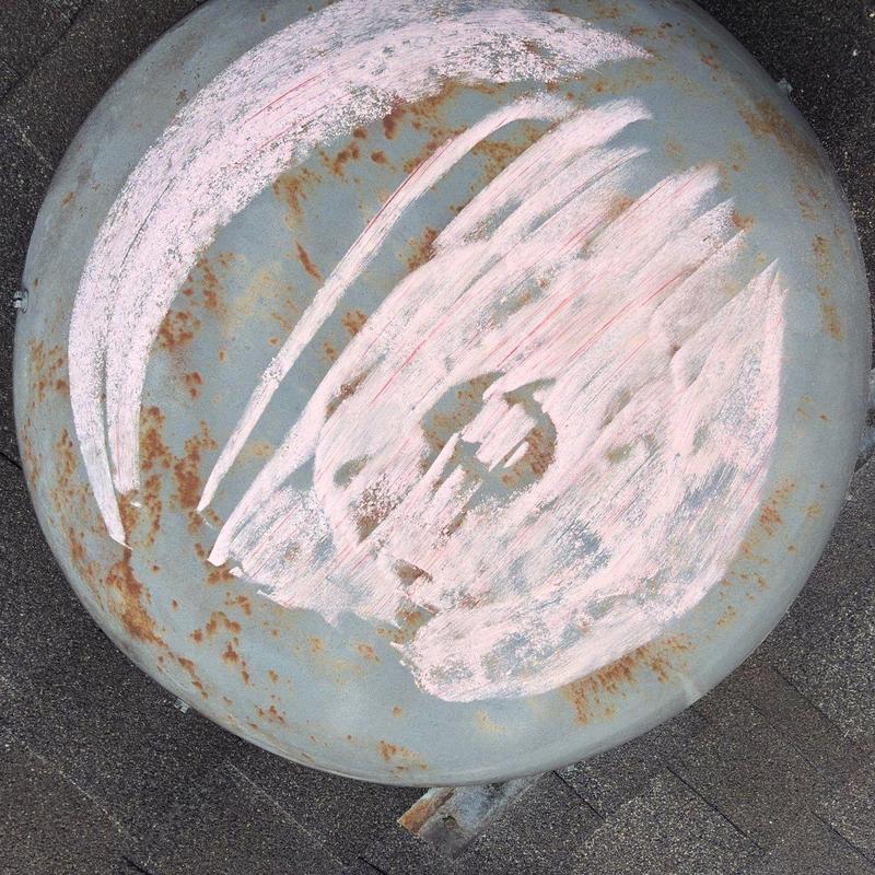 Satellite dish rust and paint damage on roof surface