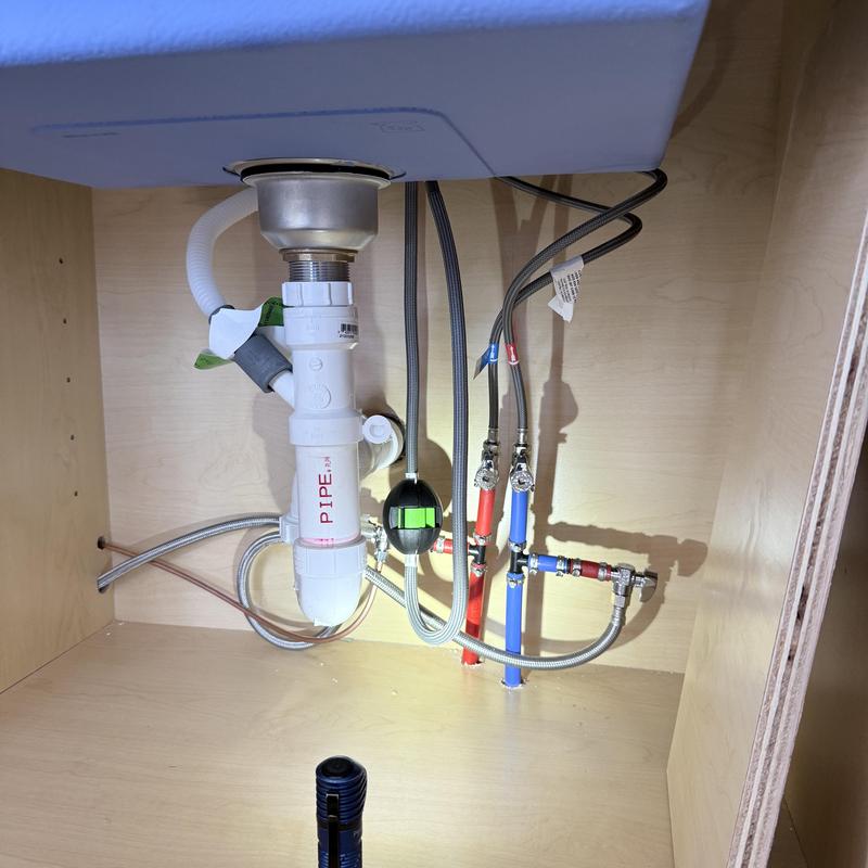 Kitchen sink drain and icemaker supply lines with stops