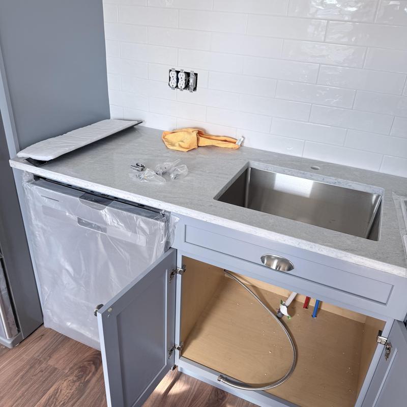 Kitchen sink plumbing with new drains and emergency stops