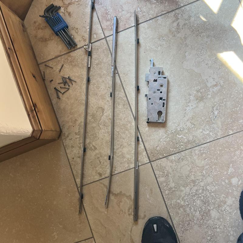 Multipoint lock components and hex keys on tile floor Multipoint lock components and hex keys on tile floor