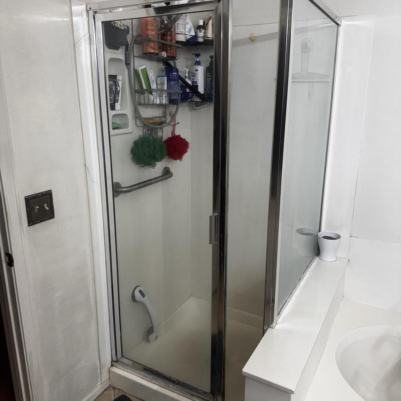Shower enclosure with cracked glass and leak damage Shower enclosure with cracked glass and leak damage