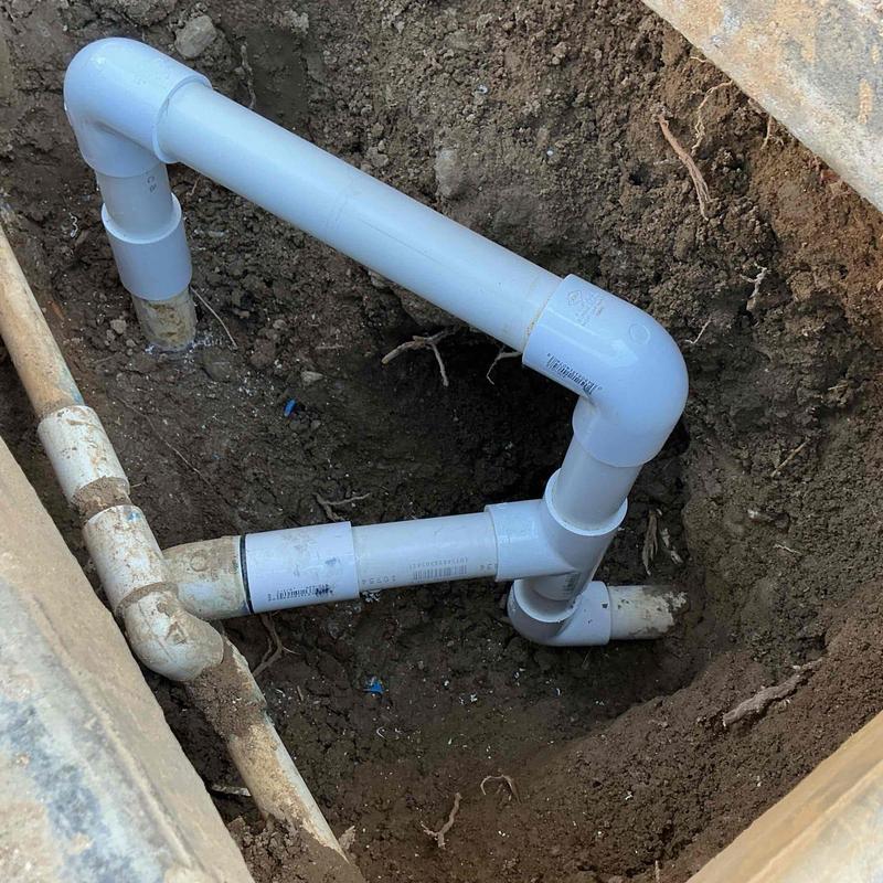PVC irrigation tee fitting connected to main waterline