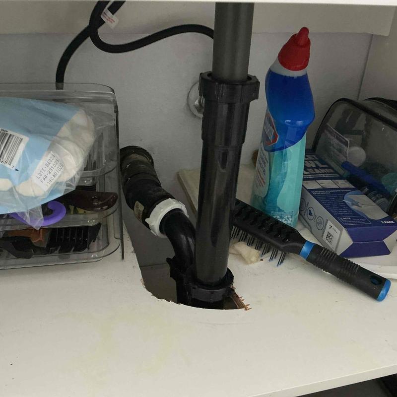 Under-sink drainage pipe with new seals and cabinet cutout