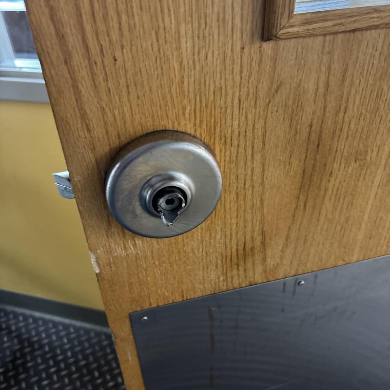 Door lever with broken handle on wooden door Door lever with broken handle on wooden door
