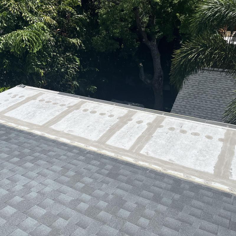 Elite panel roof section with sealant lines near shingles Elite panel roof section with sealant lines near shingles
