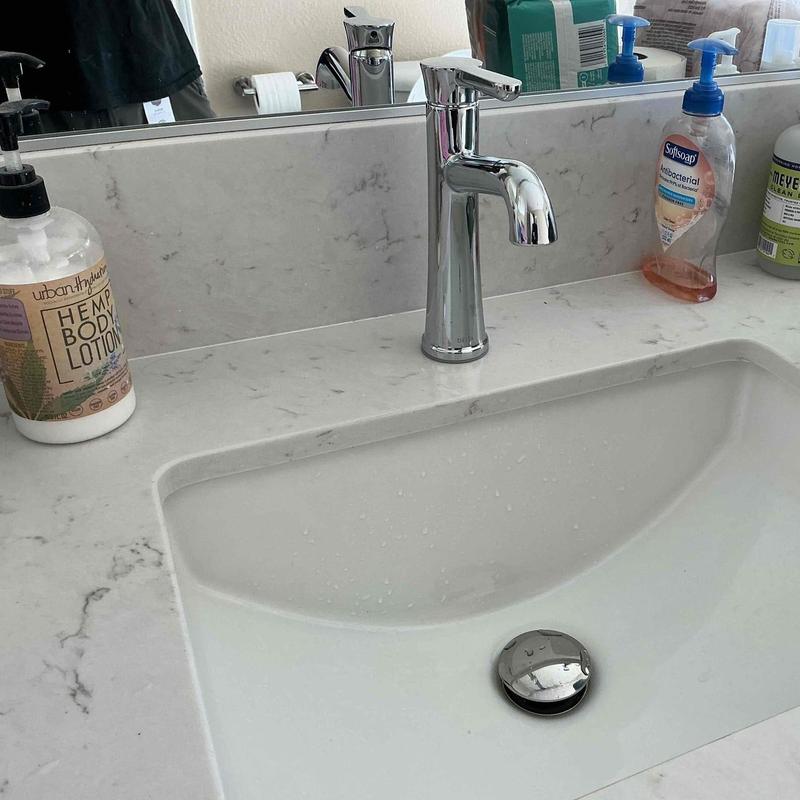 Delta bathroom faucet with supply lines on countertop