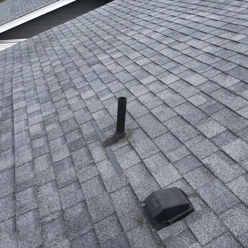 Asphalt shingle roof with vent pipe and roof vent