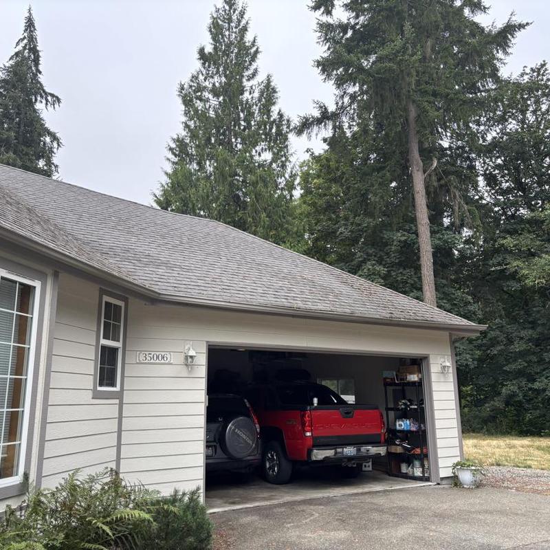 Asphalt shingle roof cleaning on residential house
