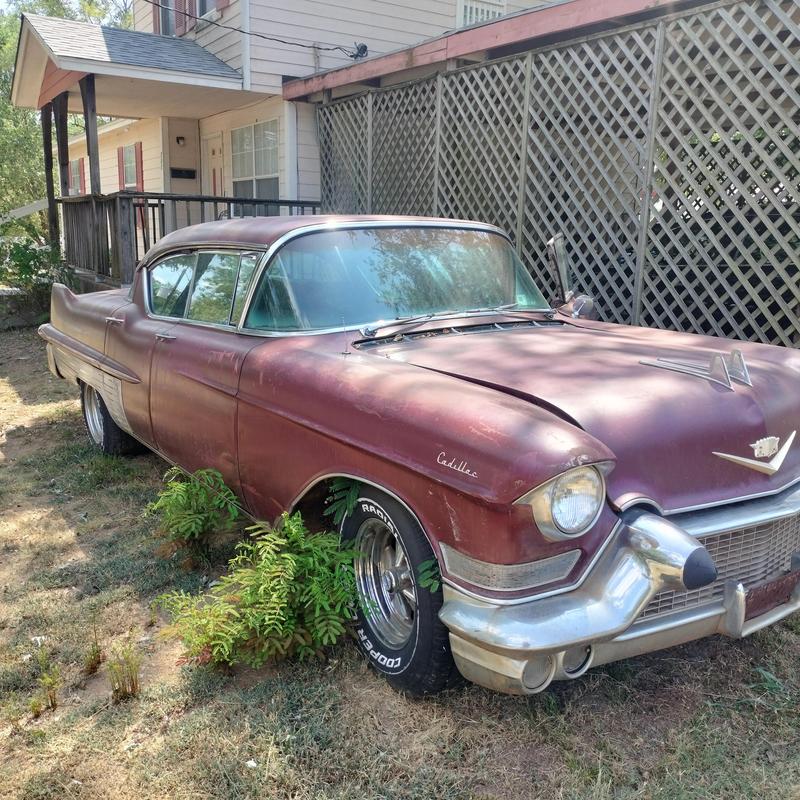 Cadillac car with vintage rusted exterior parked outdoors
