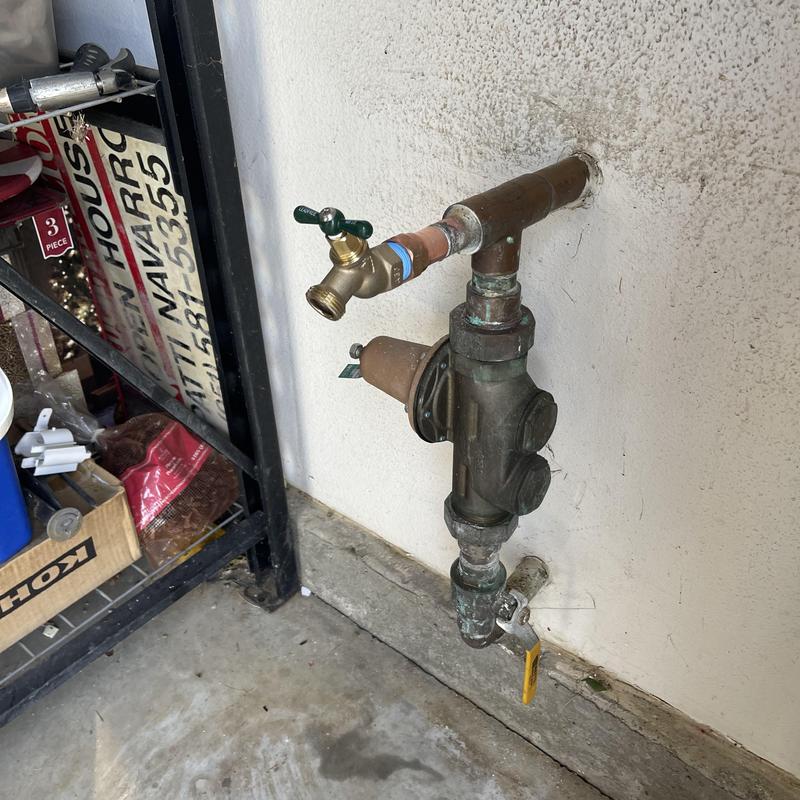 Threaded hose bib installed on exterior wall