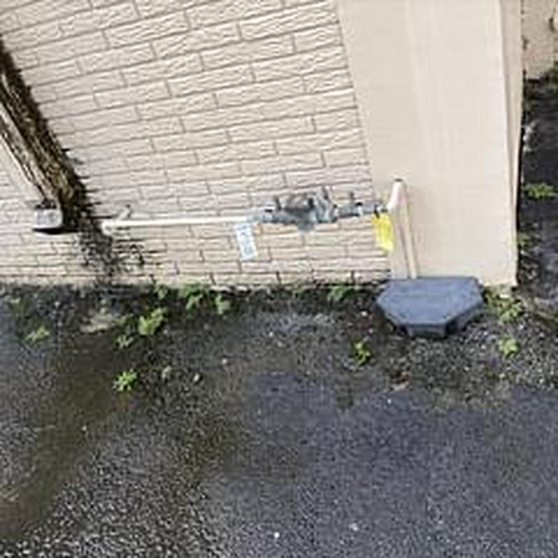 Backflow prevention device with test tags on wall
