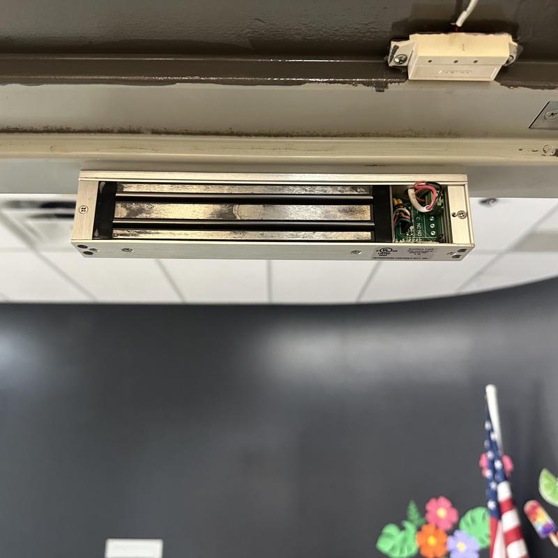 Magnetic lock installed on door frame for security Magnetic lock installed on door frame for security