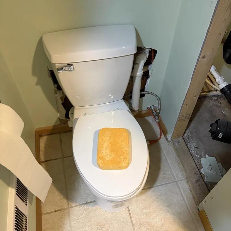 Toilet installation with exposed plumbing repairs