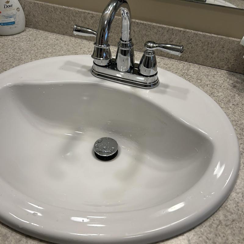 Bathroom faucet and pop-up drain assembly on sink Bathroom faucet and pop-up drain assembly on sink