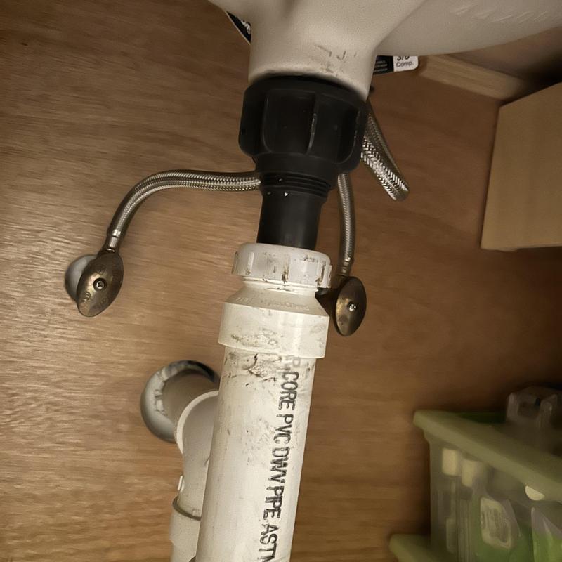 PVC drain pipe under bathroom sink with supply lines PVC drain pipe under bathroom sink with supply lines