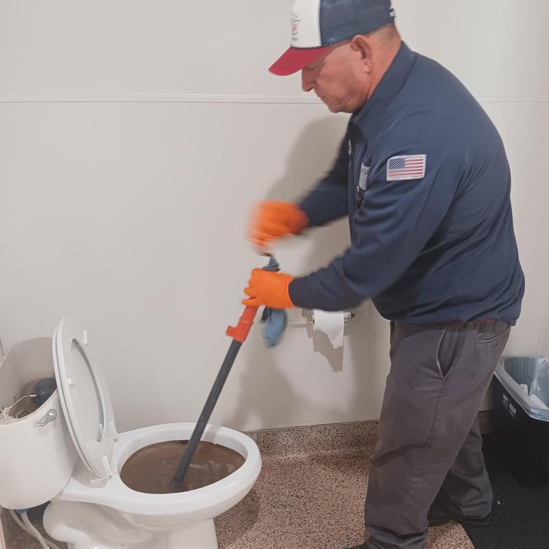 Toilet drain snaking with plumber using auger tool Toilet drain snaking with plumber using auger tool