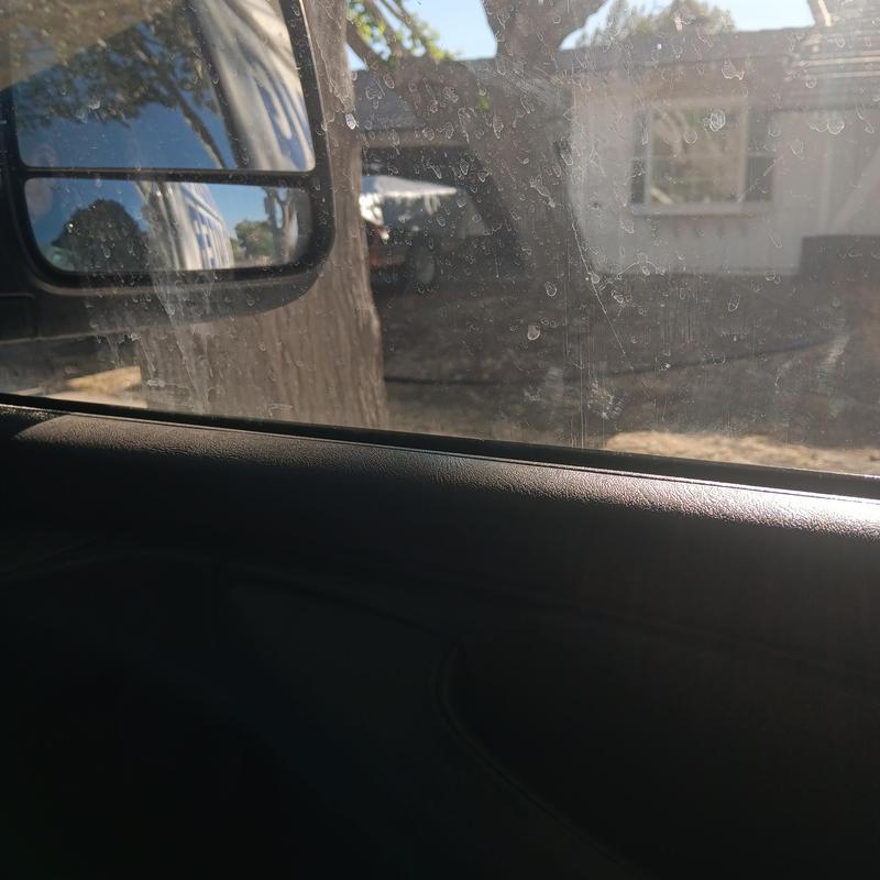 Dirty vehicle window with water spots and smudges Dirty vehicle window with water spots and smudges