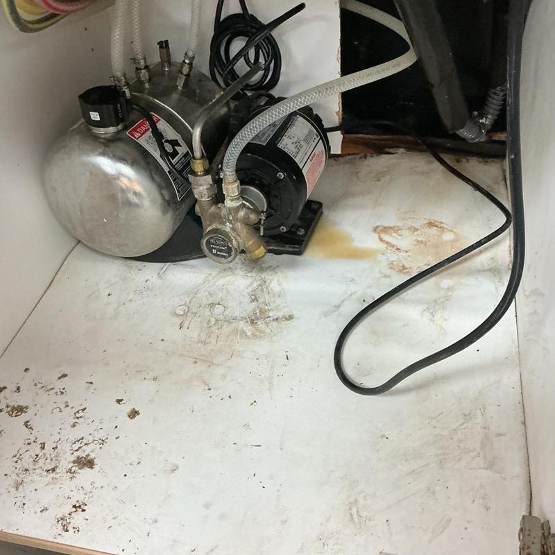 Soda machine drainage hose and pump system under cabinet