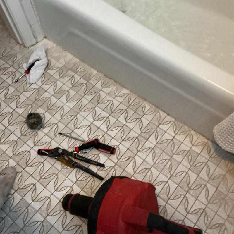 Bathtub drain with plumbing tools and drain snake