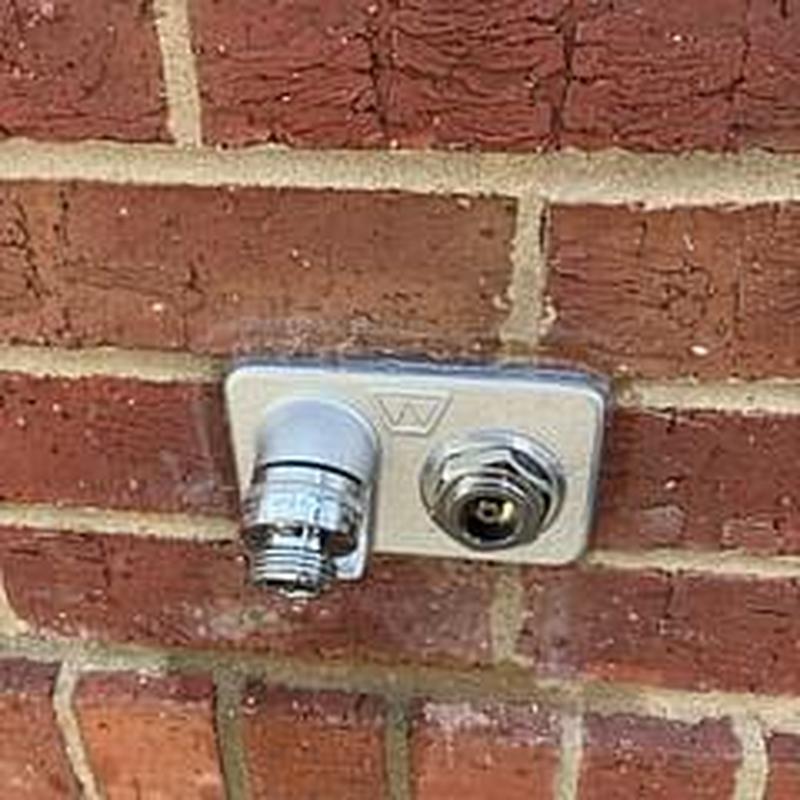 Commercial outdoor hose faucet installation on brick wall Commercial outdoor hose faucet installation on brick wall
