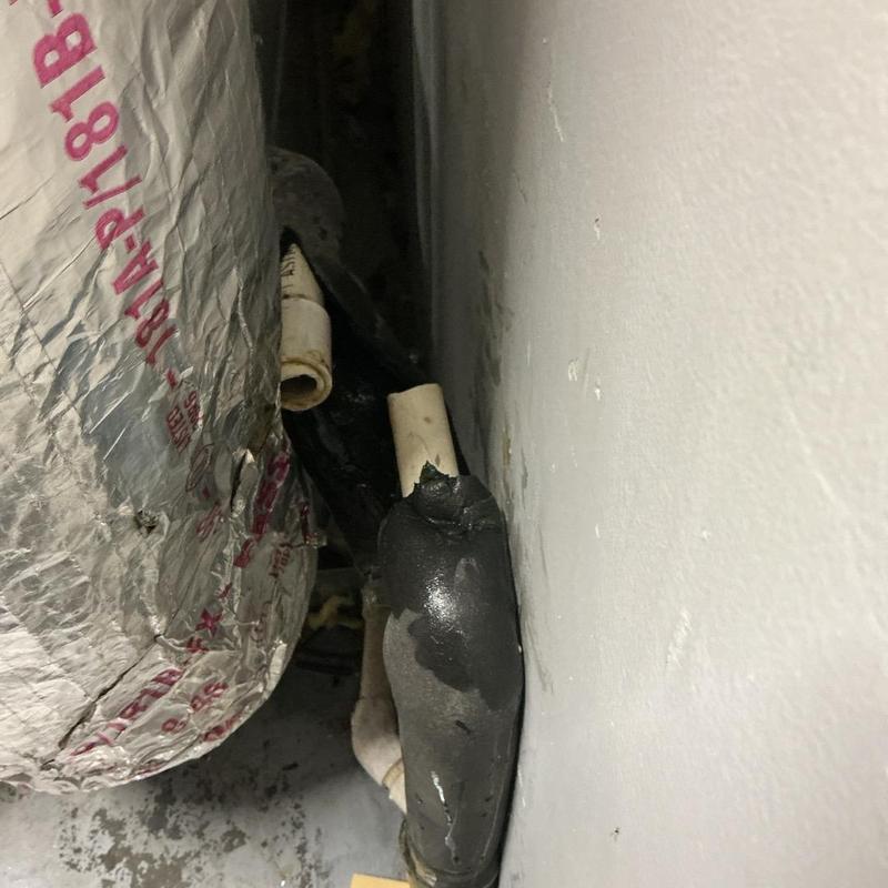 AC handler pipe with torn insulation near wall