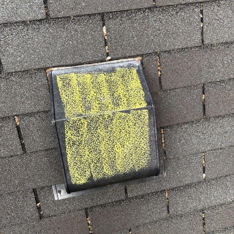 Roof vent with hail damage on asphalt shingles