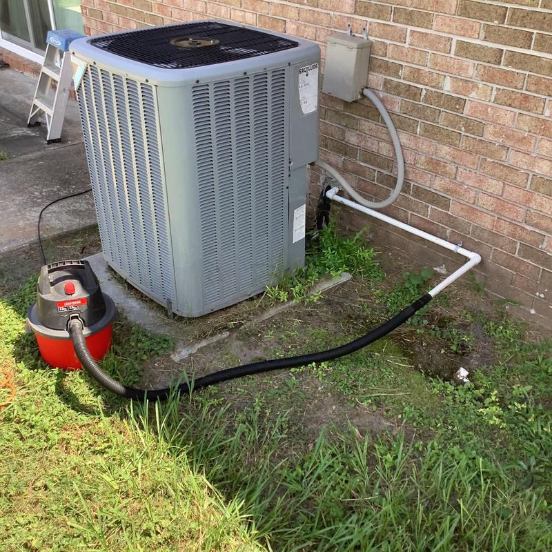 AC condensate drain line cleaning with vacuum tool outdoors AC condensate drain line cleaning with vacuum tool outdoors