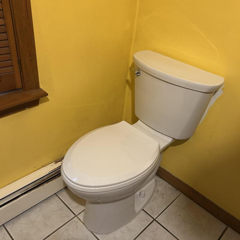 Toilet installation in a yellow bathroom corner Toilet installation in a yellow bathroom corner