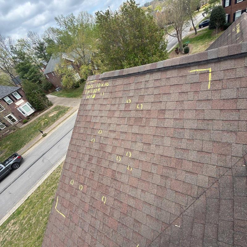 Asphalt shingle roof with hail damage marks and notes