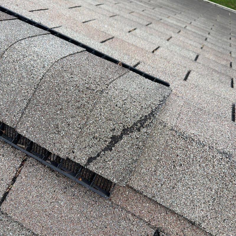 Asphalt shingles with visible hail impact damage