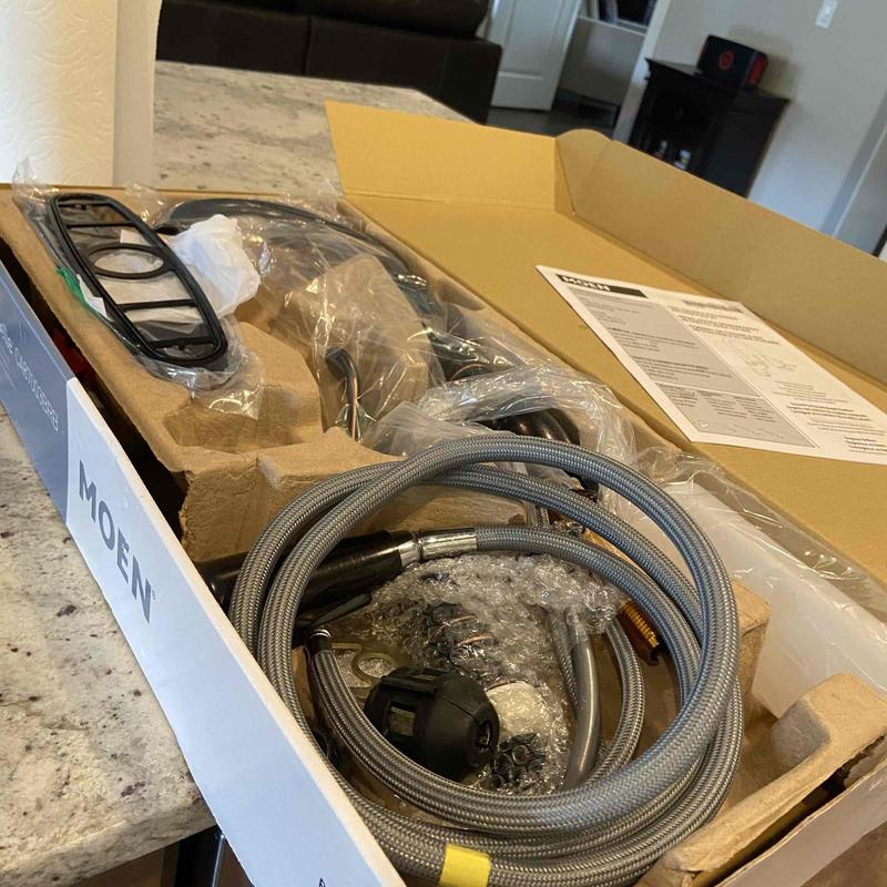 Kitchen faucet kit with hoses and components in box Kitchen faucet kit with hoses and components in box