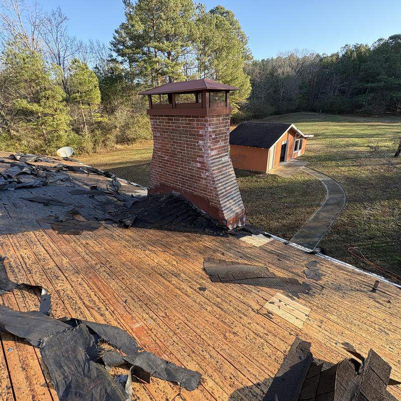 Asphalt roof shingles removal near chimney in Rome, GA Asphalt roof shingles removal near chimney in Rome, GA