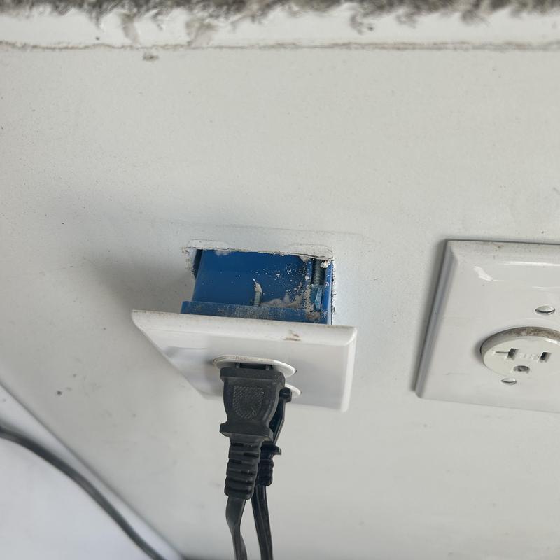 Electrical receptacle with missing cover plate and plug Electrical receptacle with missing cover plate and plug