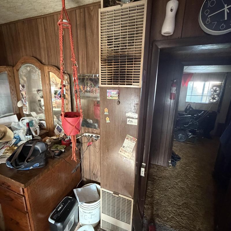 Wall furnace with vent grille and cluttered surroundings Wall furnace with vent grille and cluttered surroundings