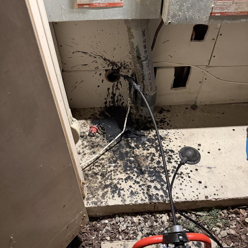 Main sewer line with black sludge and cleaning equipment Main sewer line with black sludge and cleaning equipment