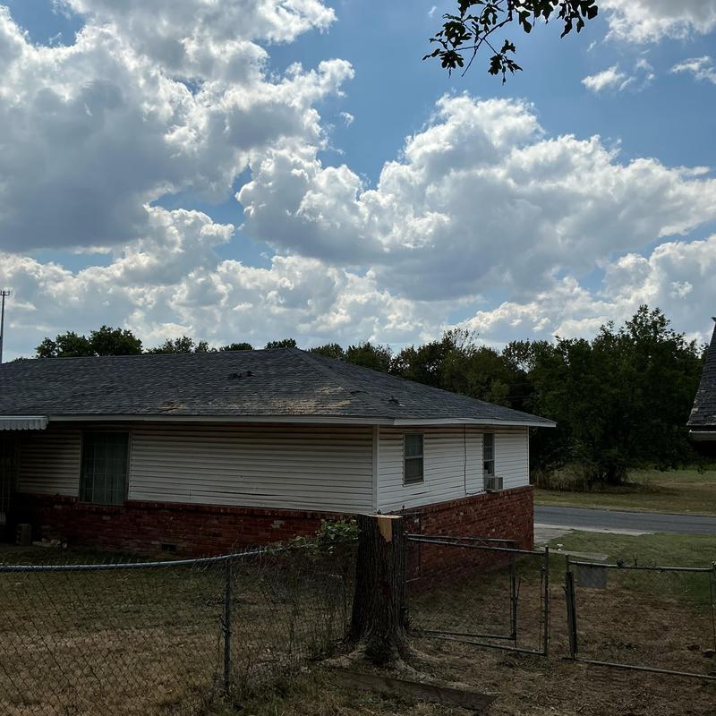 Tree stump and damaged roof after removal in McAlester Tree stump and damaged roof after removal in McAlester
