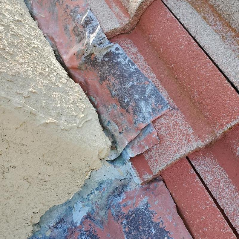Clay tile roof flashing with sealant repair details