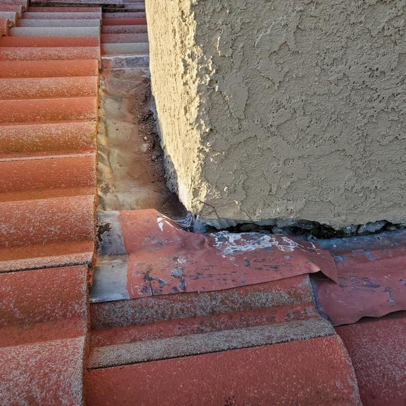 Tile roof flashing around stucco chimney base