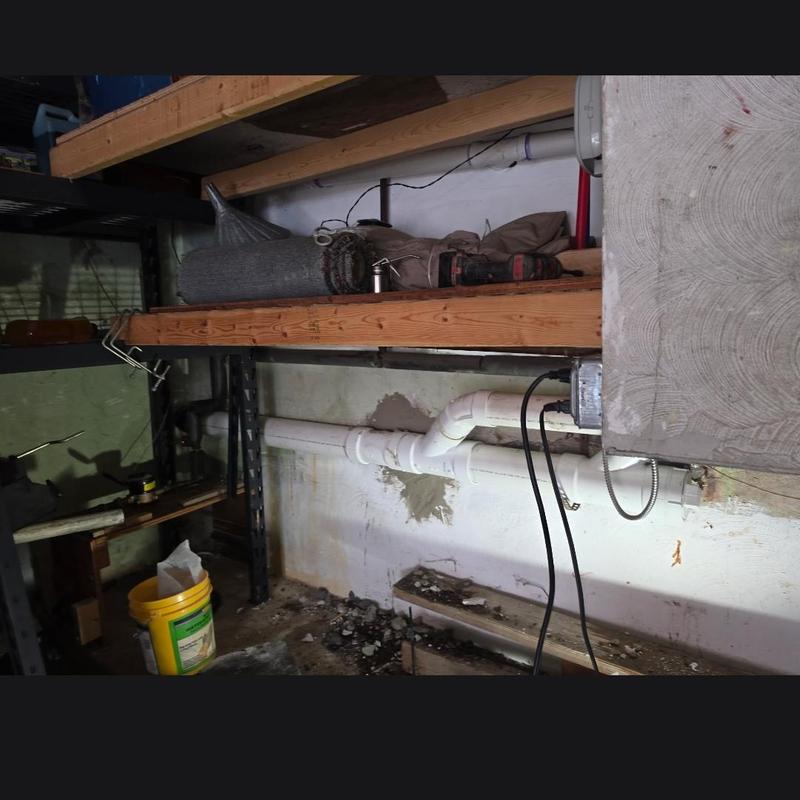 PVC sewer pipe replacement in basement wall area