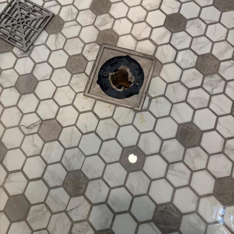 Shower drain with tile grout and tape residue